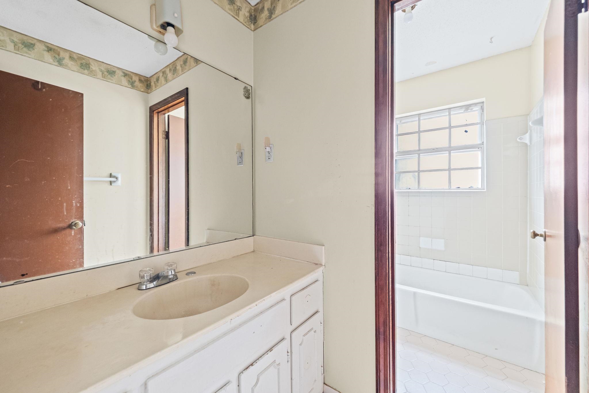2967 Meadowfair Road Memphis, TN 38118 - Photo 12 of 19 a bathroom with a granite countertop sink and a mirror