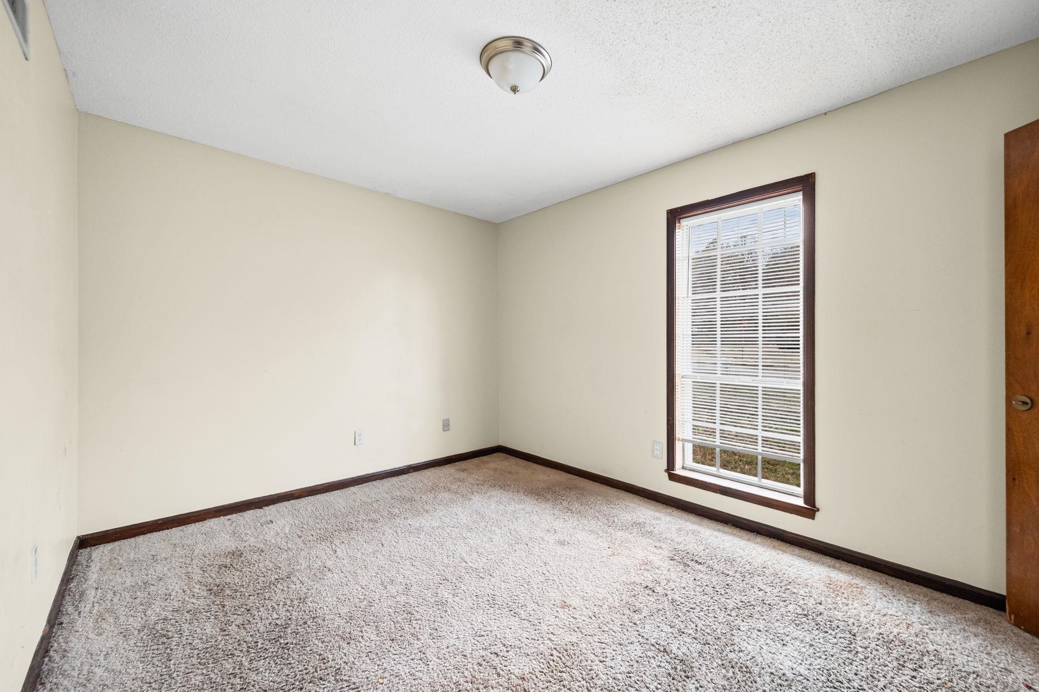 2967 Meadowfair Road Memphis, TN 38118 - Photo 7 of 19 an empty room with windows