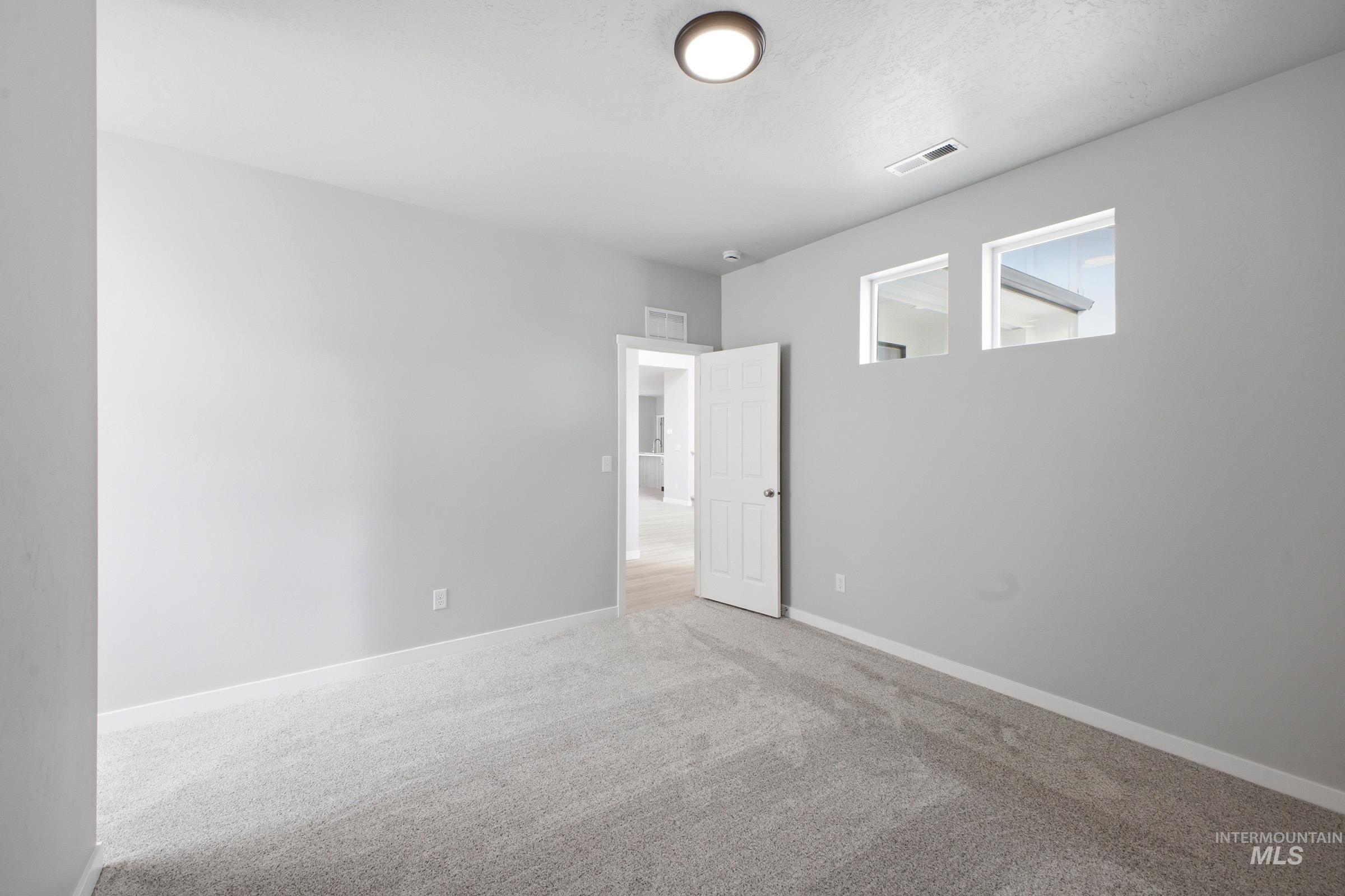 13672 Redway Court Caldwell, ID 83607 - Photo 15 of 34 Spare room featuring light carpet and baseboards