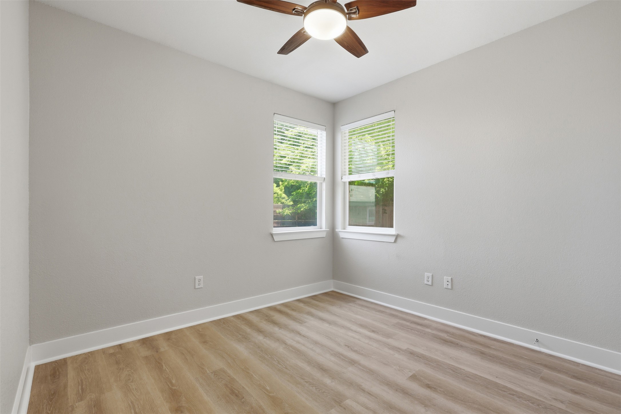 7208 Lysander Court Austin, TX 78741 - Photo 11 of 15 an empty room with a window and a ceiling fan
