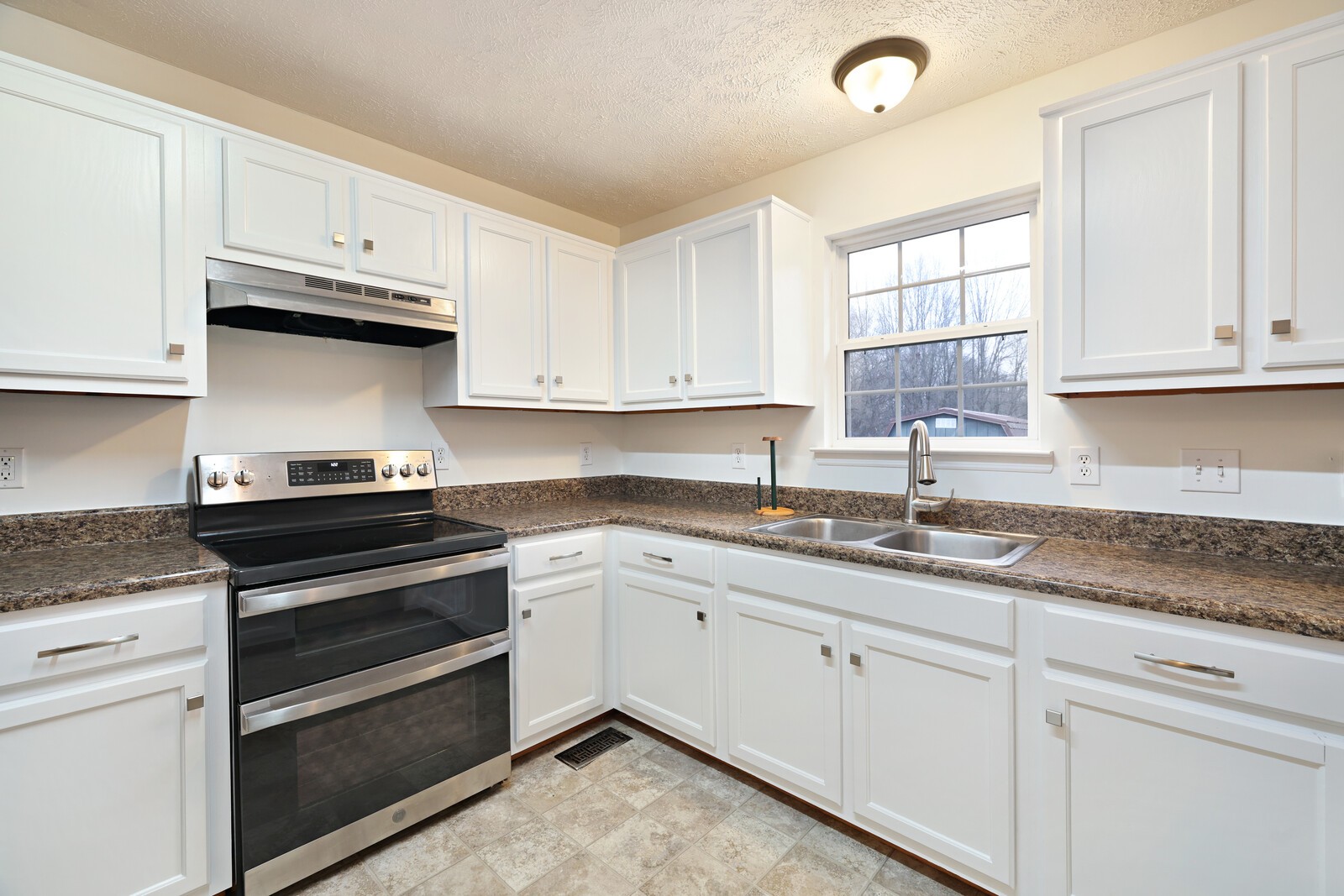 808 Jonathan Drive Lebanon, TN 37087 - Photo 12 of 29 a kitchen with granite countertop white cabinets and a sink