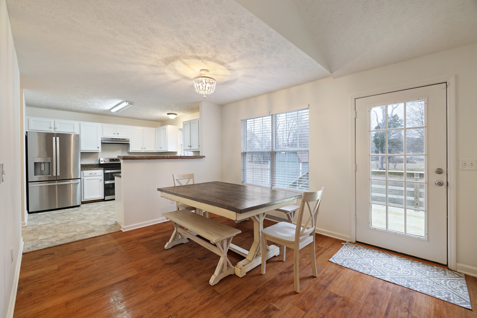 808 Jonathan Drive Lebanon, TN 37087 - Photo 9 of 29 a kitchen with granite countertop a stove a sink dishwasher a refrigerator with wooden floor and cabinets