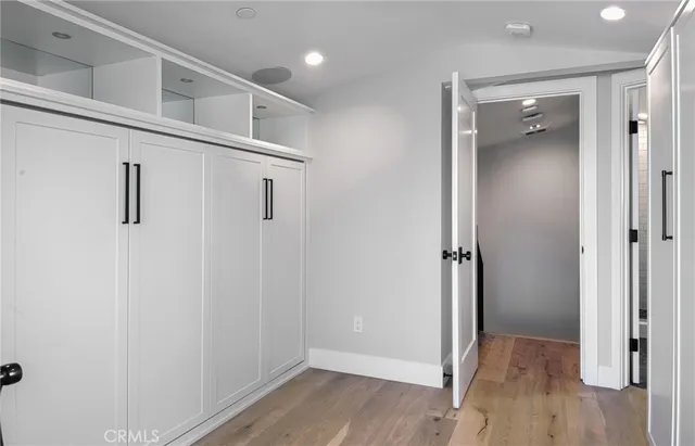 a view of hallway with wooden floor