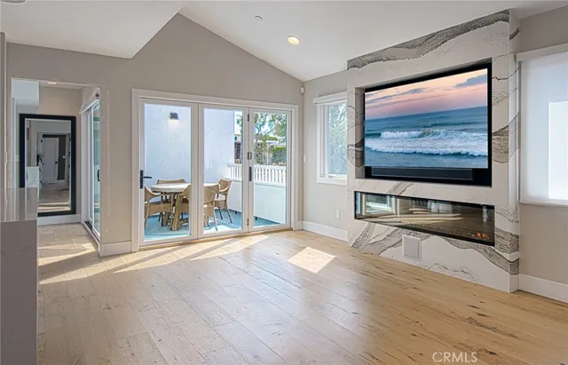 a view of a livingroom with wooden floor and a flat screen tv