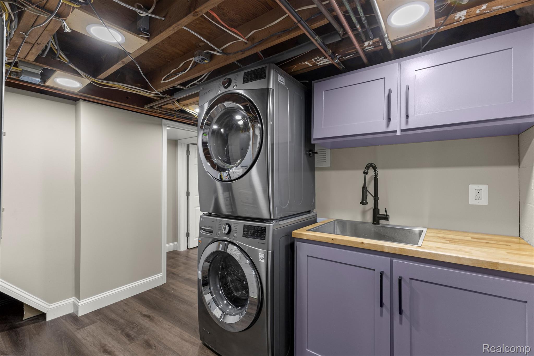 45401 West 9 Mile Road Novi, MI 48374 - Photo 28 of 67 Washroom featuring stacked washer / drying machine, dark wood-style flooring, and cabinet space
