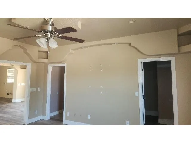 a open living room with a ceiling fan