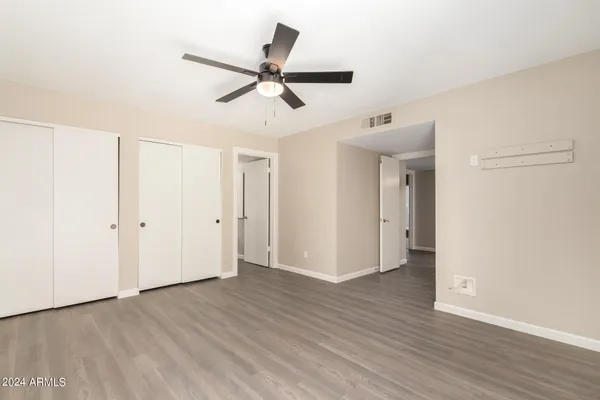 a bathroom with a sink a toilet a mirror and shower