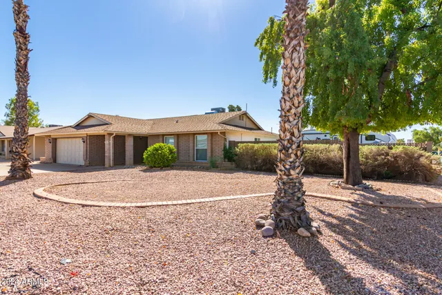 a front view of a house with a yard and a garage