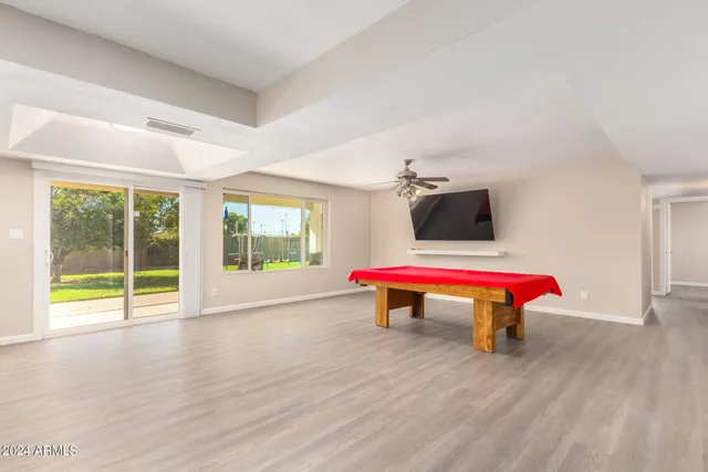 an empty room with wooden floor and fireplace