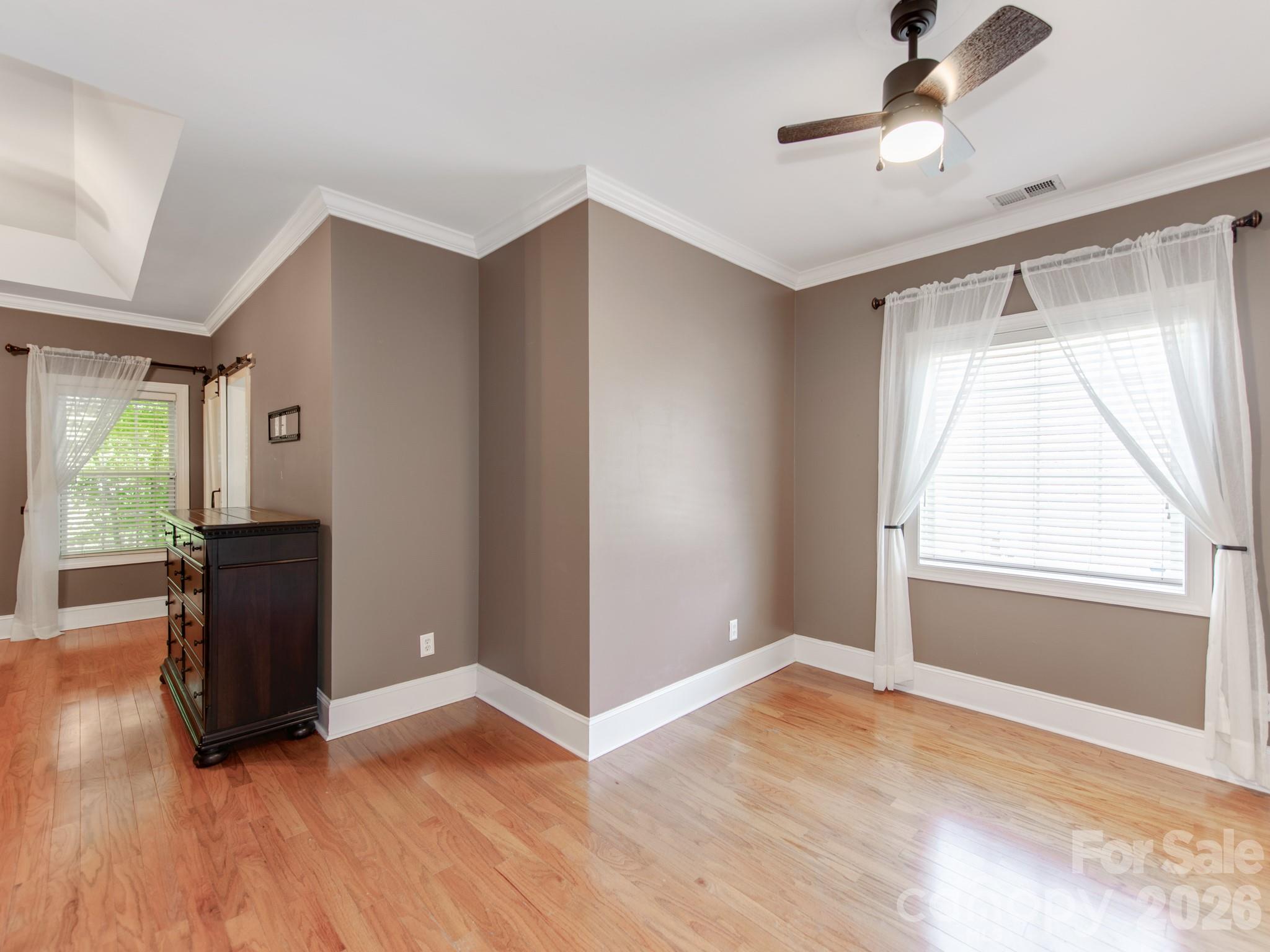 783 Sloan Street Denver, NC 28037 - Photo 19 of 44 a view of empty room with wooden floor and fan