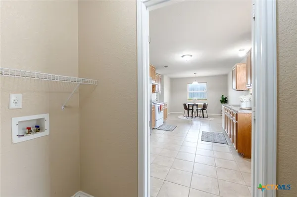 a view of kitchen with furniture and a refrigerator