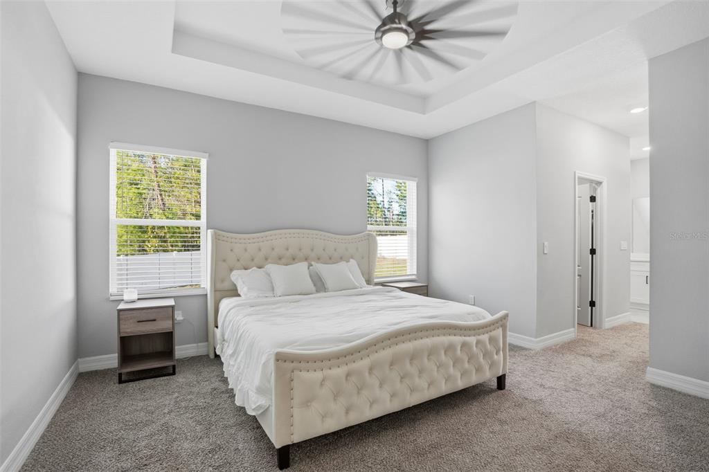 8549 Southwest 129 Lane Ocala, FL 34473 - Photo 20 of 31 a bedroom with a bed and a chandelier