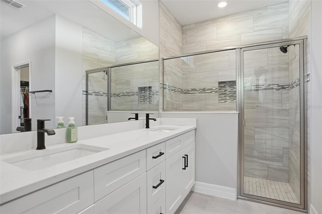 8549 Southwest 129 Lane Ocala, FL 34473 - Photo 26 of 31 a bathroom with a double vanity sink and mirror