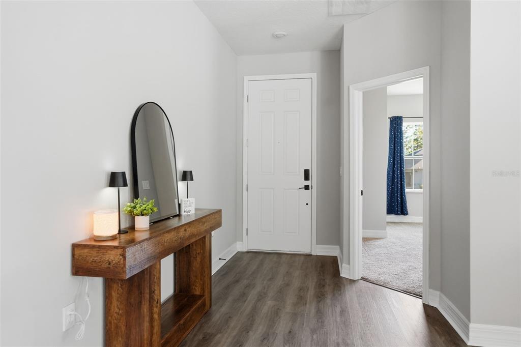 8549 Southwest 129 Lane Ocala, FL 34473 - Photo 4 of 31 a view of a hallway with wooden floor and furniture