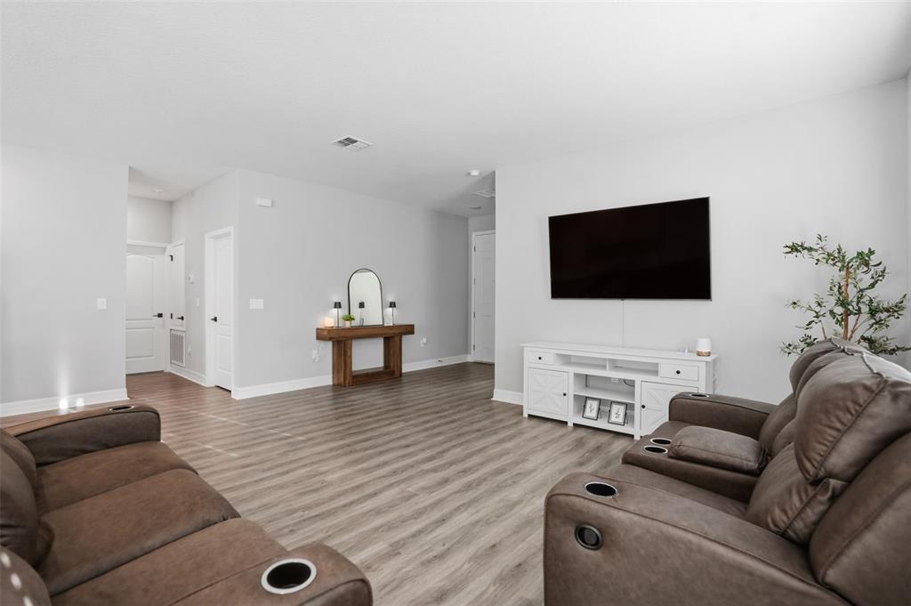 8549 Southwest 129 Lane Ocala, FL 34473 - Photo 6 of 31 a living room with furniture and a flat screen tv