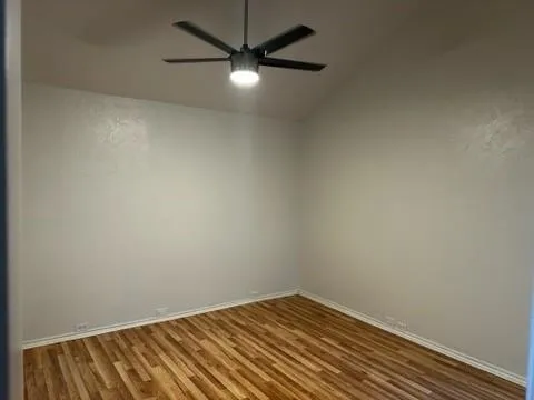an empty room with a fan & a fan