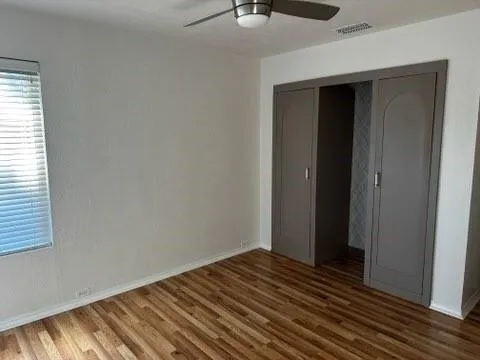 a view of a room with wooden floor and closet