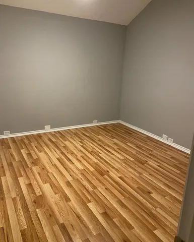 a view of a room with wooden floor