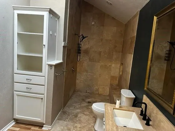 a bathroom with a sink toilet and shower