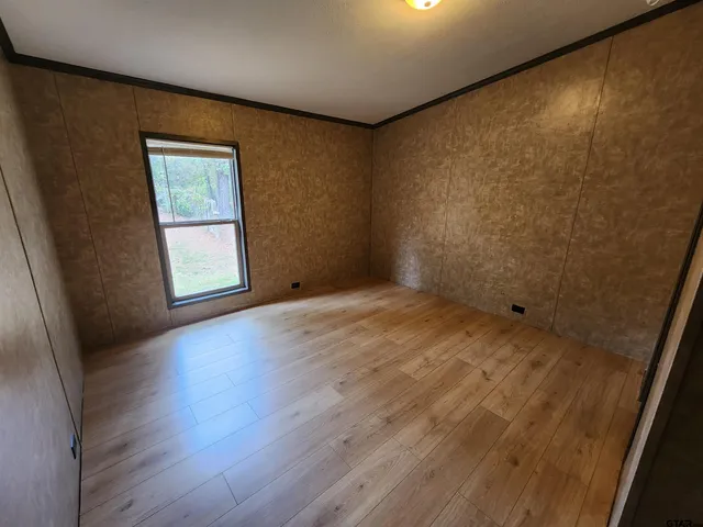 a bathroom with a granite countertop sink a mirror and a shower