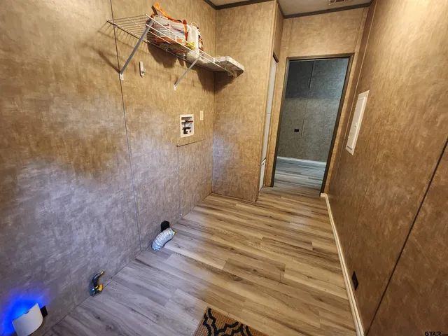a view of a room with a ceiling fan hardwood floor and a ceiling fan