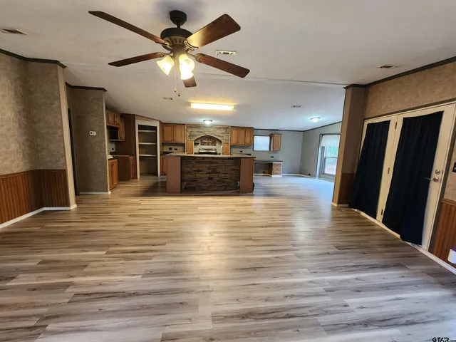 a view of kitchen with sink microwave and refrigerator