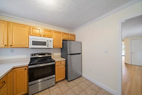 a kitchen with a refrigerator stove and microwave