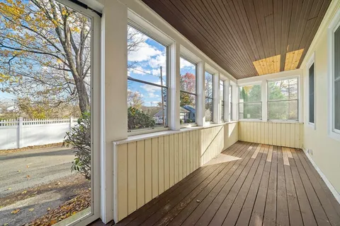 a view of a room with wooden floor and windows