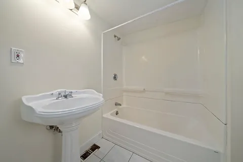 a bathroom with a sink a mirror and a bathtub