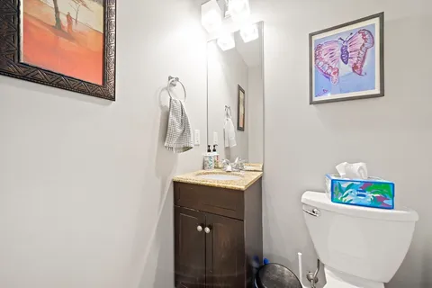 a bathroom with a sink a toilet and a mirror