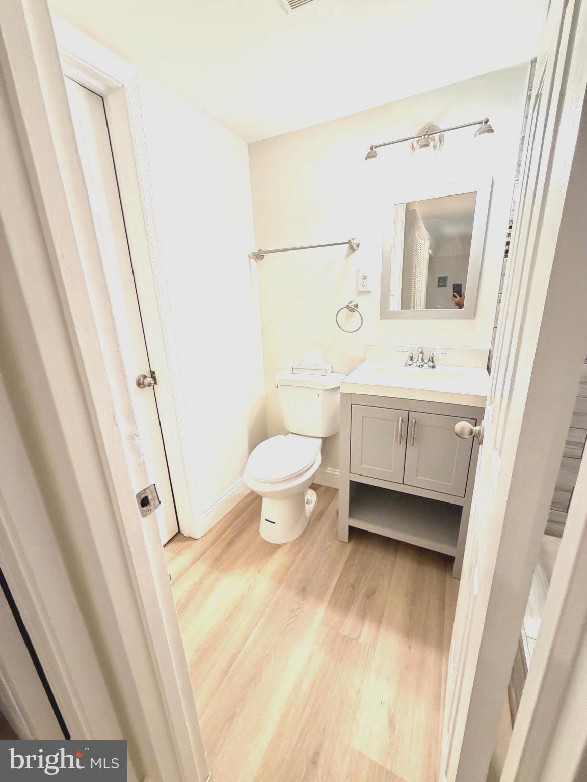 2316 Freetown Court, Unit 1B Reston, VA 20191 - Photo 23 of 36 a bathroom with a toilet sink and mirror
