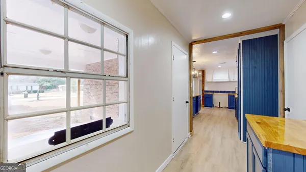 a view of a bathroom with a tub and windows