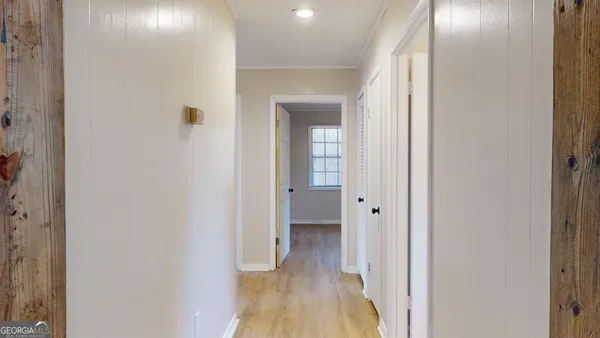 a view of a hallway with wooden floor