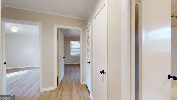 a view of a hallway with wooden floor