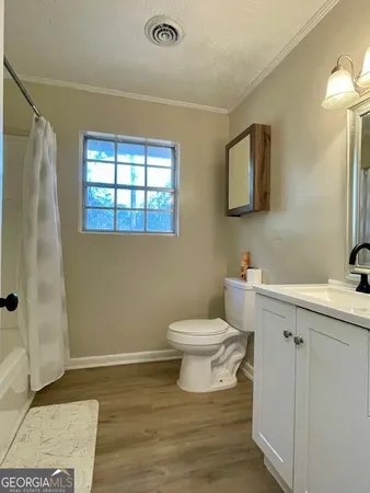 a bathroom with a toilet sink and a mirror