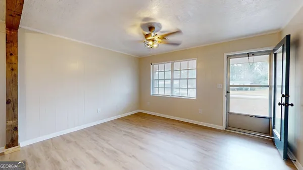 wooden floor in an empty room with a window