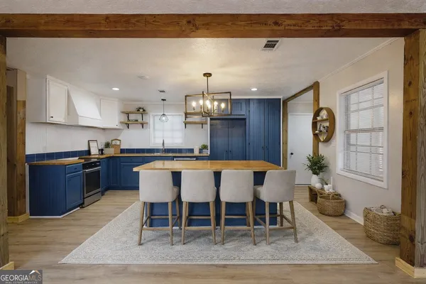a large kitchen with a table and chairs