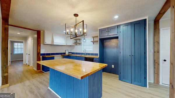 a kitchen with stainless steel appliances granite countertop wooden floors and granite counter tops