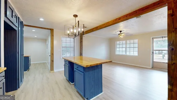 a view of a room with wooden floor and staircase