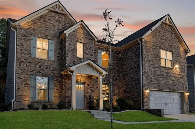 a front view of a house with a yard