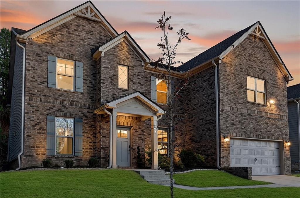 a front view of a house with a yard