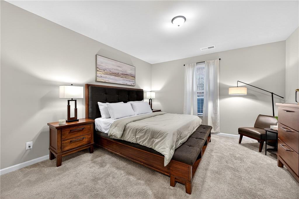 4863 Sultana Way Atlanta, GA 30331 - Photo 15 of 42 a bedroom with a bed and wooden floor