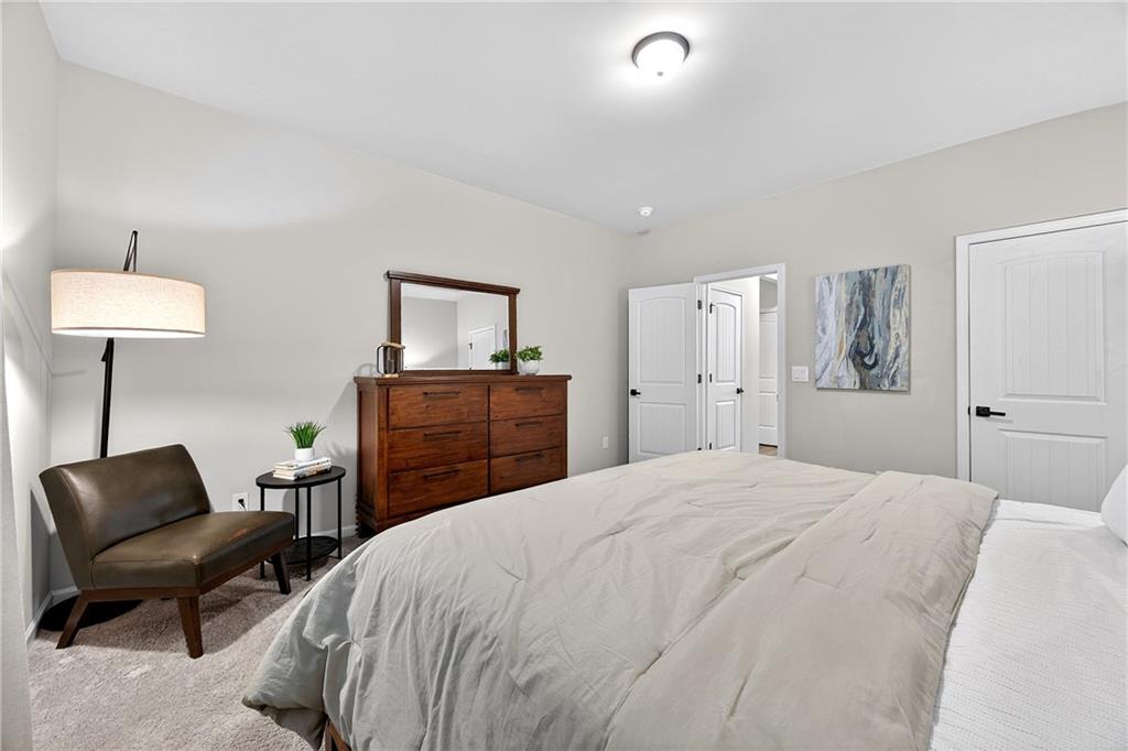 4863 Sultana Way Atlanta, GA 30331 - Photo 16 of 42 a bedroom with a bed and a chair