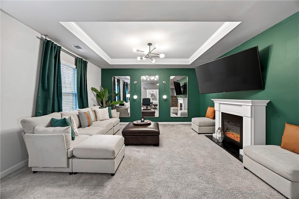 4863 Sultana Way Atlanta, GA 30331 - Photo 24 of 42 a living room with furniture a flat screen tv and a fireplace