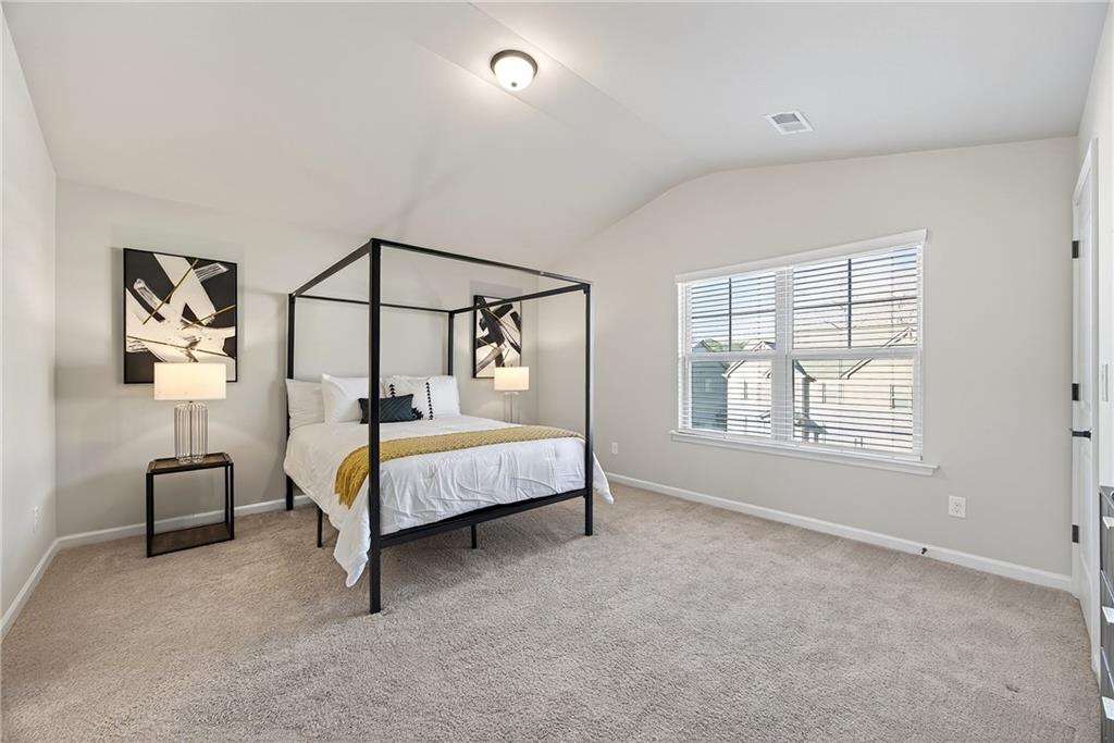 4863 Sultana Way Atlanta, GA 30331 - Photo 28 of 42 a bedroom with a bed a table and painting