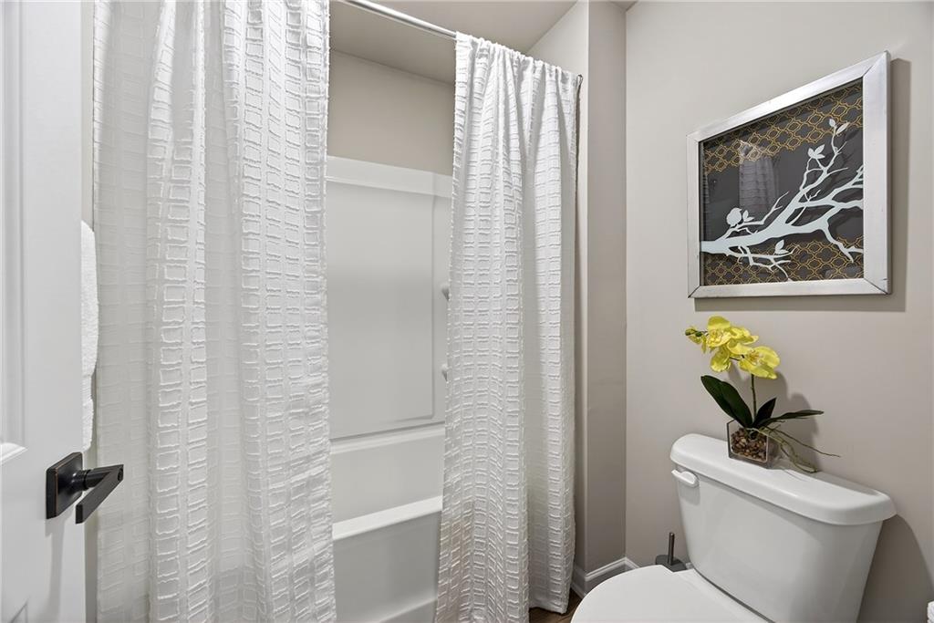 4863 Sultana Way Atlanta, GA 30331 - Photo 31 of 42 a white toilet sitting next to a bathroom sink