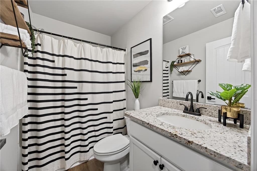 4863 Sultana Way Atlanta, GA 30331 - Photo 34 of 42 a bathroom with a granite countertop sink mirror vanity and toilet