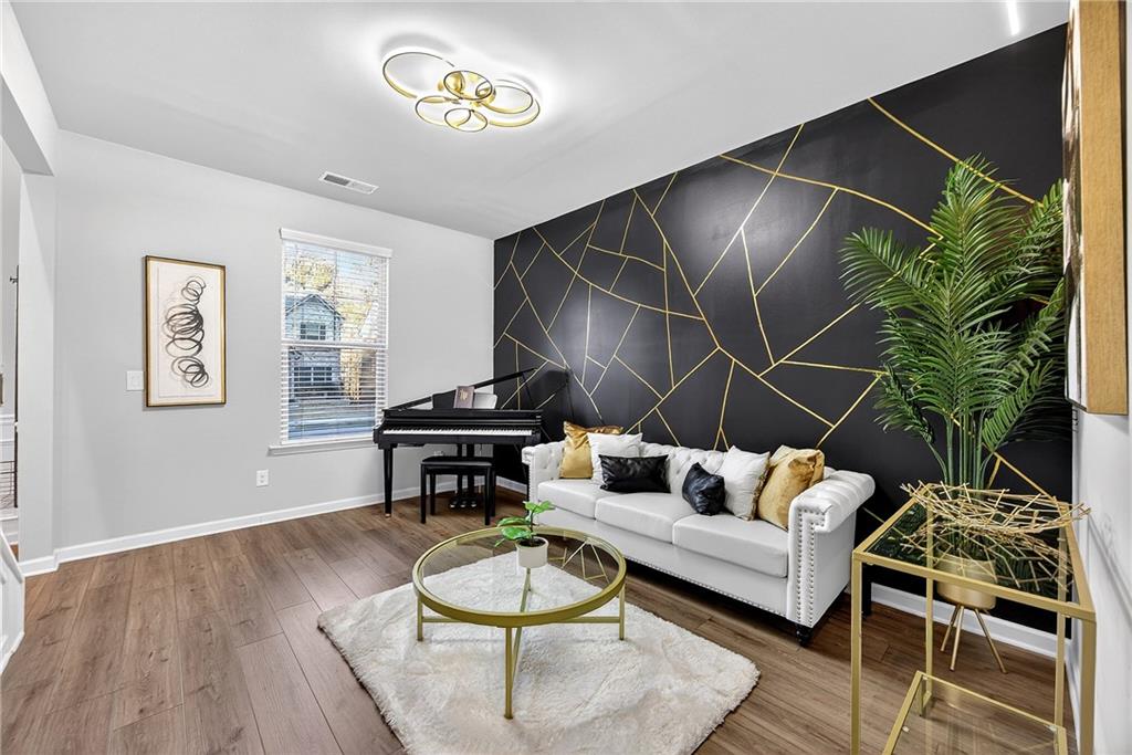 4863 Sultana Way Atlanta, GA 30331 - Photo 6 of 42 a living room with furniture and a wooden floor