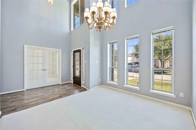 an empty room with windows and entrance