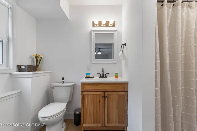 a white toilet sitting next to a bathroom sink